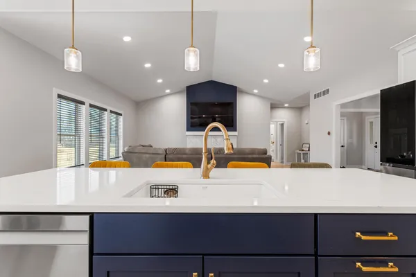 a kitchen with kitchen island a sink stainless steel appliances and window