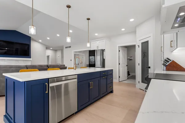 a kitchen with stainless steel appliances granite countertop a sink a stove and a refrigerator