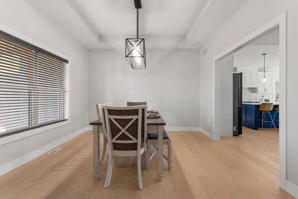 a view of a dining room with furniture and chandelier