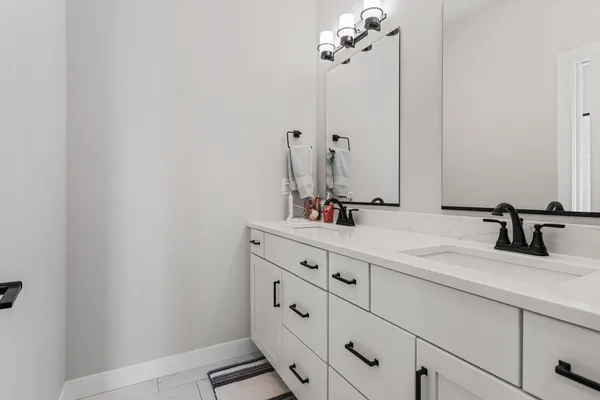 a bathroom with a sink vanity and a mirror