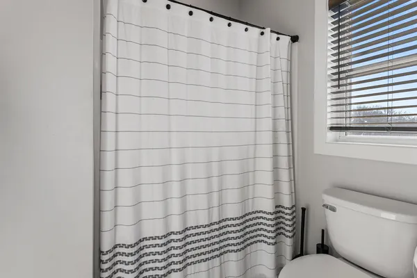 a bathroom with a shower and a toilet