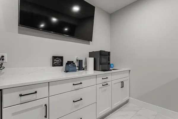 a living room with furniture a flat screen tv and a window