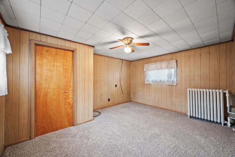 6438 Wampum Mt Air Road Wampum, PA 16157 - Photo 22 of 42 an empty room with a window and a ceiling fan
