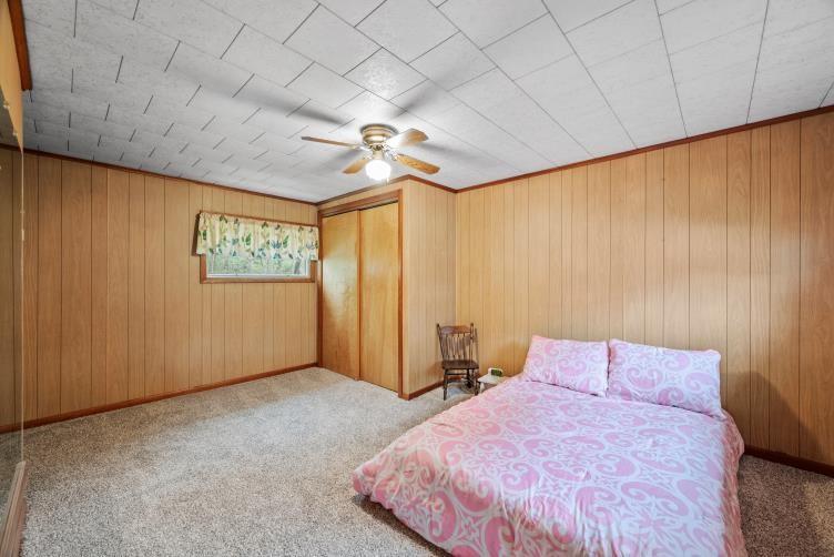 6438 Wampum Mt Air Road Wampum, PA 16157 - Photo 24 of 42 a bedroom with a bed and a chandelier