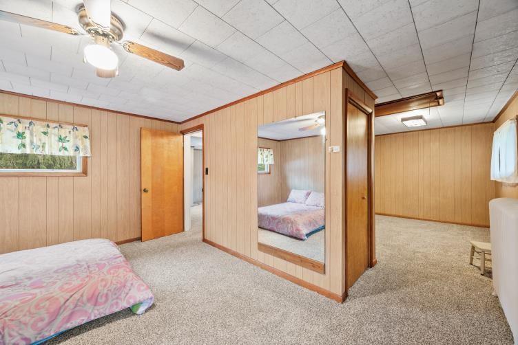 6438 Wampum Mt Air Road Wampum, PA 16157 - Photo 25 of 42 a bedroom with a bed and a chandelier