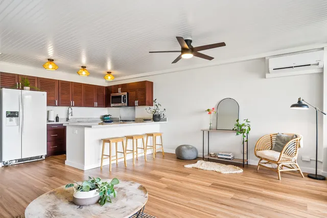 a living room with furniture and a floor to ceiling window