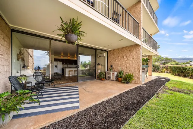 a view of potted plants in front of a building