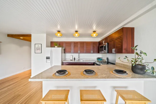 a kitchen with a stove and a white refrigerator