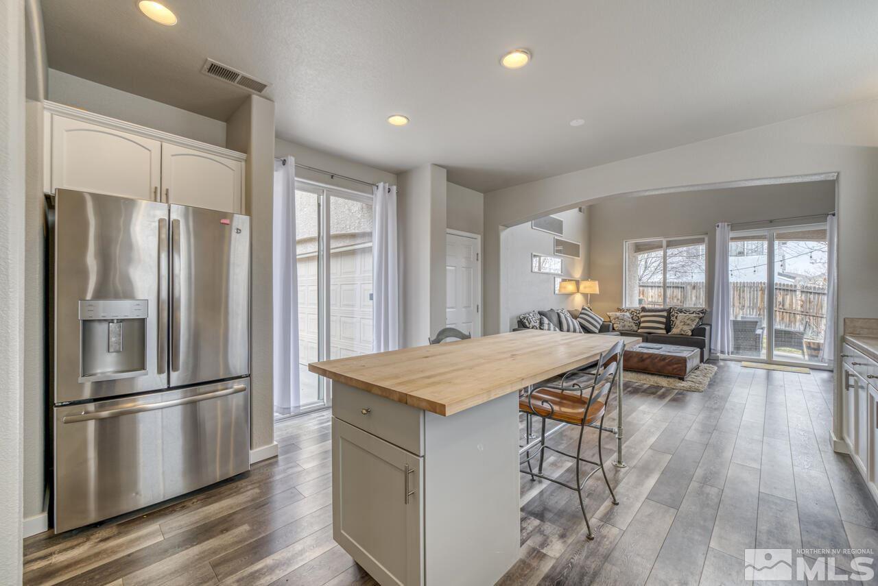 1795 Back Country Road Reno, NV 89521 - Photo 5 of 21 a kitchen with a refrigerator a stove and a wooden floors