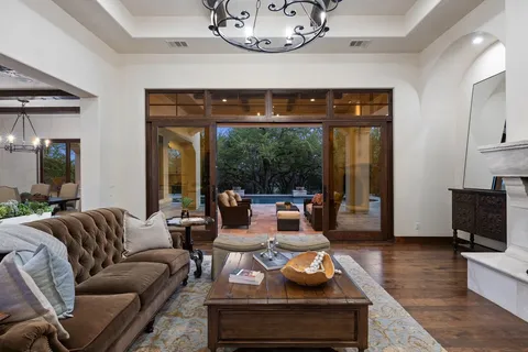 a living room with furniture chandelier and a fireplace