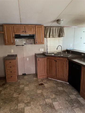 a kitchen with a sink and cabinets