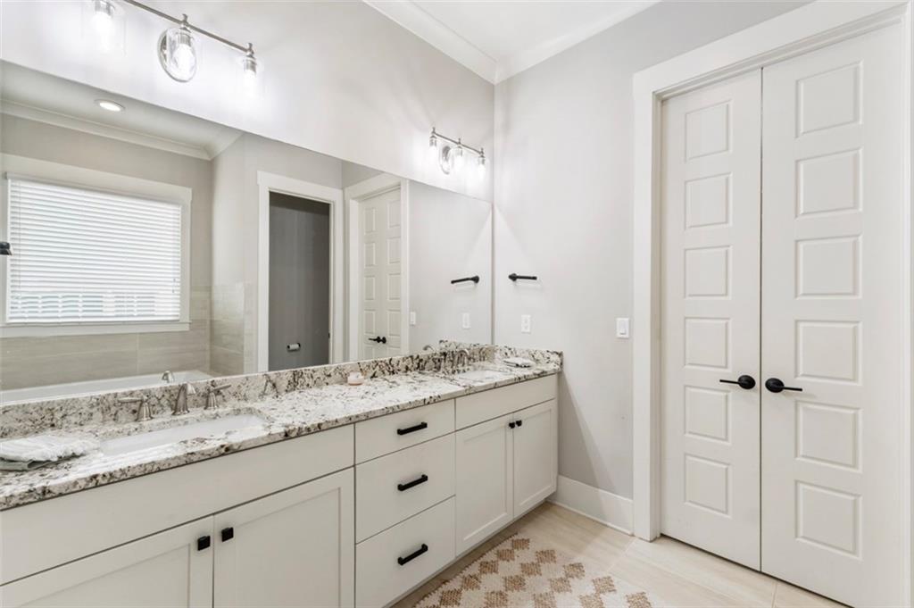 1909 Red Eagle Walk Atlanta, GA 30318 - Photo 22 of 61 a bathroom with a granite countertop sink and a mirror