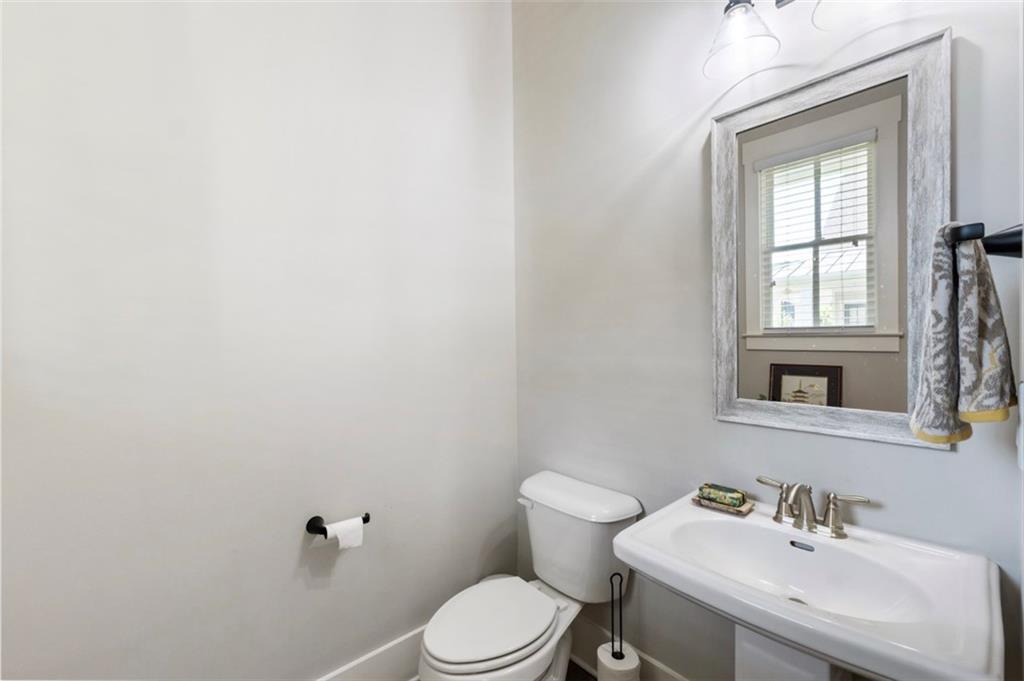 1909 Red Eagle Walk Atlanta, GA 30318 - Photo 26 of 61 a white toilet sitting next to a bathroom sink