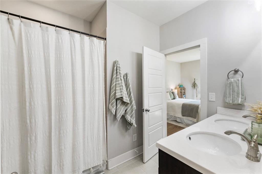 1909 Red Eagle Walk Atlanta, GA 30318 - Photo 39 of 61 a bathroom with a sink and a mirror