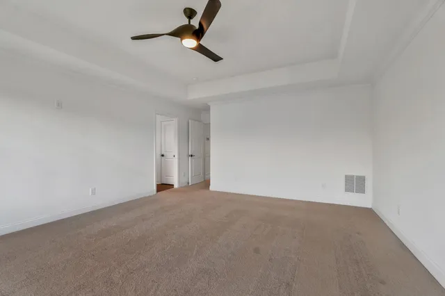 an aerial view of residential houses with outdoor space and ocean view