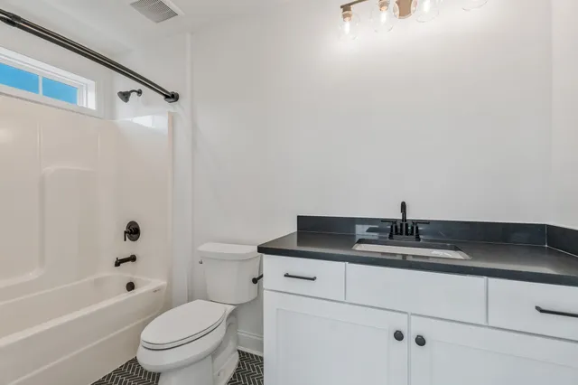 an aerial view of a house with pool lawn chairs and a fire pit