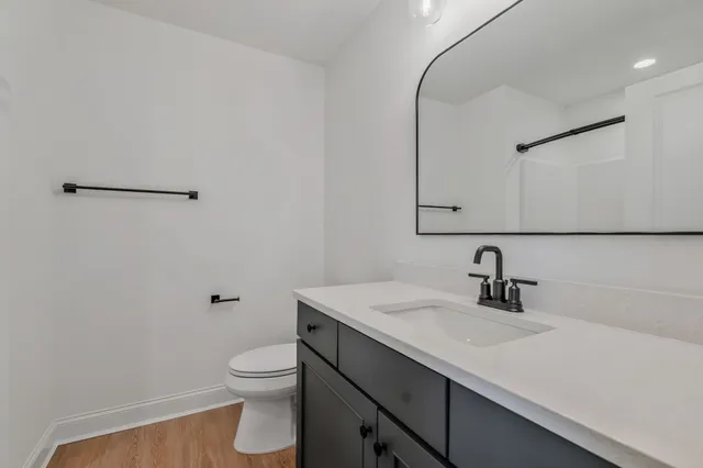 a view of a swimming pool with lawn chairs and plants