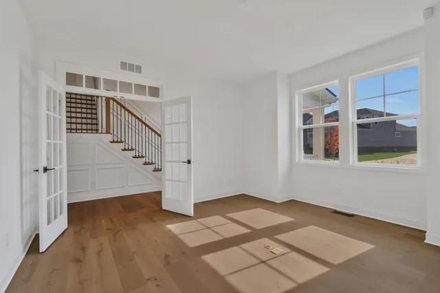 a view of an entryway with wooden floor and stairs