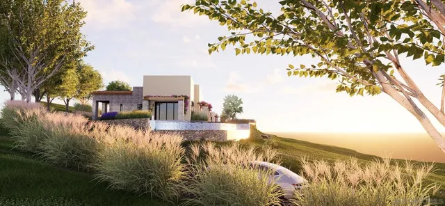 a view of residential houses with outdoor space and trees