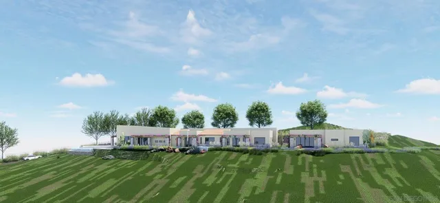 a view of a big house with a big yard and large trees