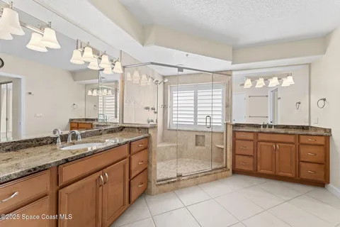 a bathroom with a granite countertop sink mirror and