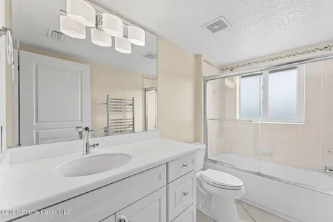 a bathroom with a sink toilet a mirror and shower