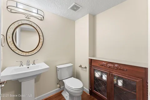 a bathroom with a toilet a sink and a mirror