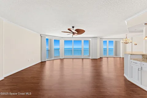 a view of empty room with wooden floor and cabinet