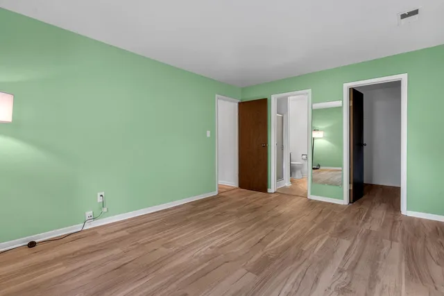 a view of room with window and wooden floor