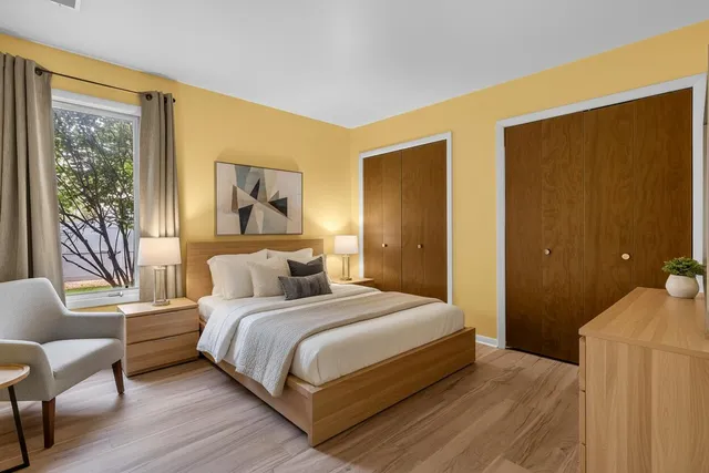 a bedroom with a bed and wooden floor