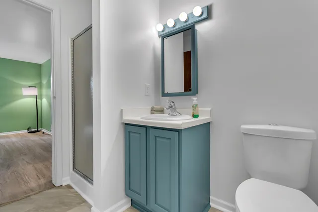 a bathroom with a toilet sink and mirror