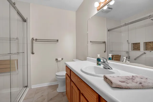 a bathroom with a sink toilet and shower