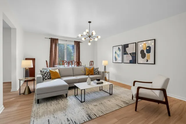 a living room with furniture and a chandelier