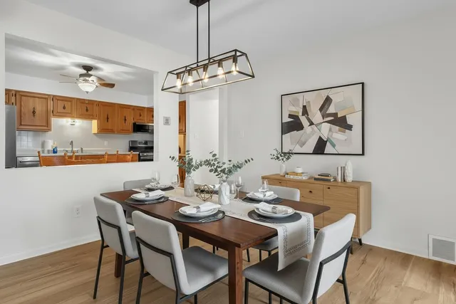 a view of a dining room with furniture wooden floor and chandelier