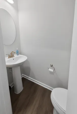 a white toilet sitting next to a bathroom sink