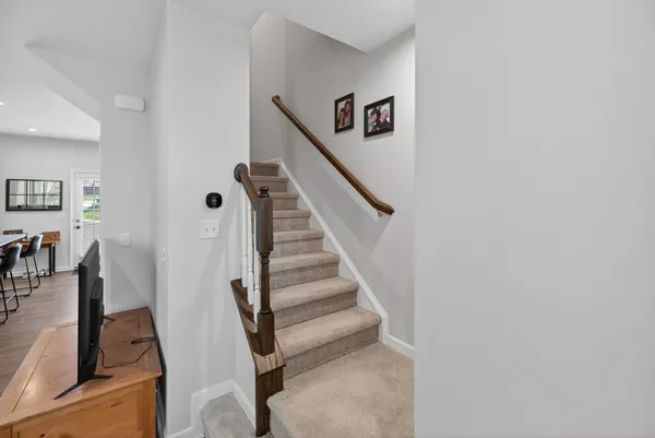 a view of entryway and hall with wooden floor