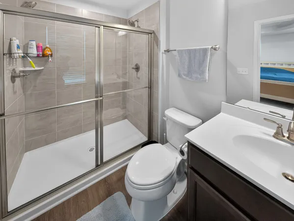 a bathroom with a sink toilet and shower