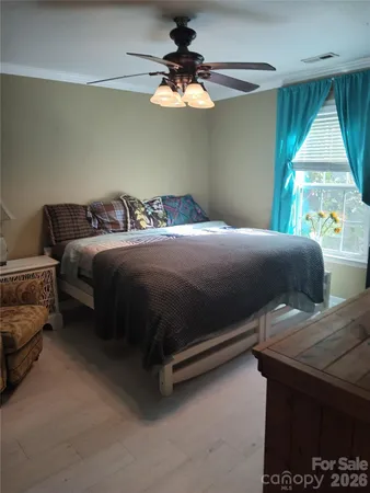 a bedroom with a bed and window