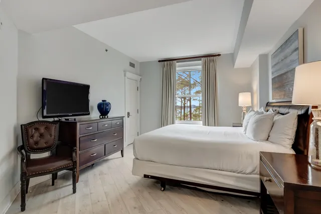 a bedroom with a bed and a flat screen tv