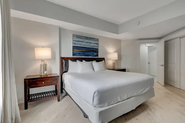 a bedroom with a bed and a night stand