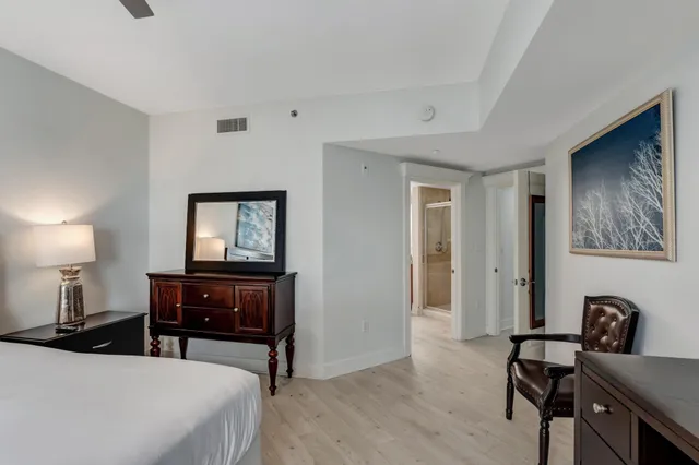 a bedroom with a bed and a desk