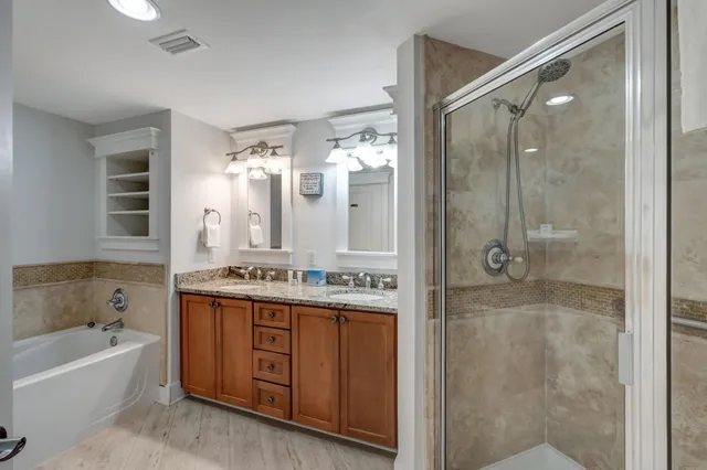 a bathroom with a double vanity sink mirror double and shower