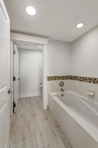 a spacious bathroom with a bathtub and a sink