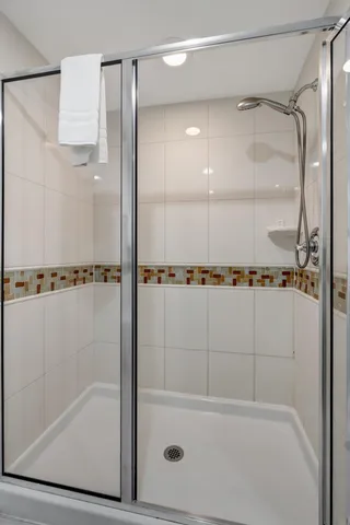 a bathroom with a shower and a bath tub