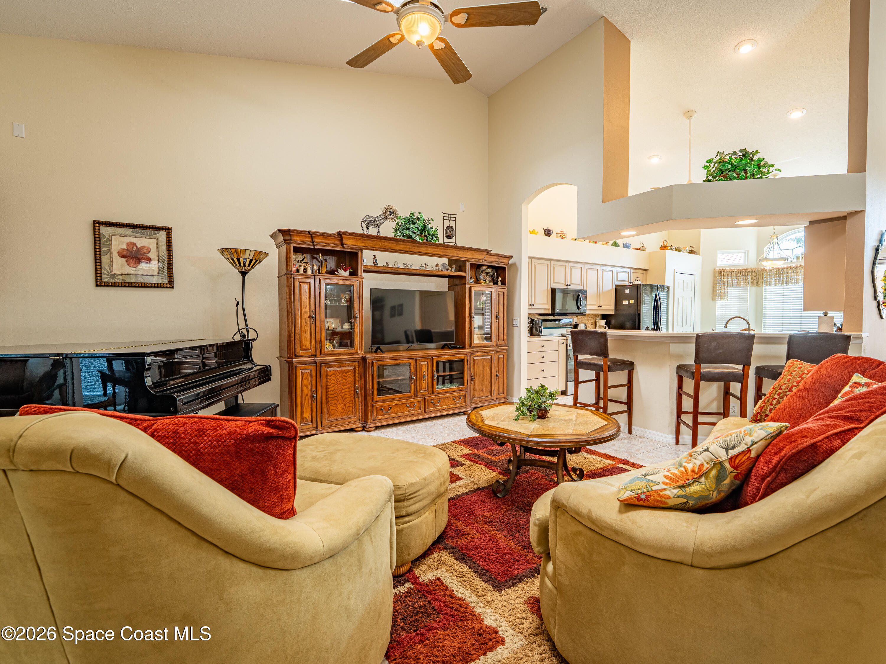 598 Renaissance Avenue Melbourne, FL 32940 - Photo 20 of 56 a living room with furniture kitchen view and a chandelier