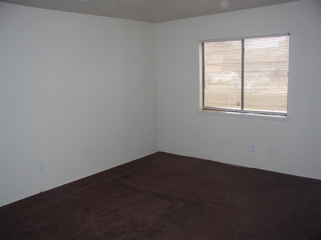 7210 Pineberry Road Dallas, TX 75249 - Photo 7 of 8 an empty room with a window