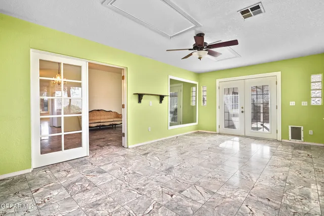 a view of a livingroom with a ceiling fan and window
