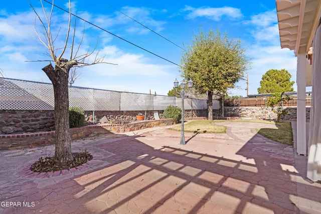 a view of a patio with table and chairs