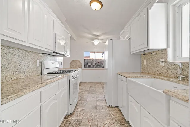 a kitchen with stainless steel appliances granite countertop a sink and cabinets