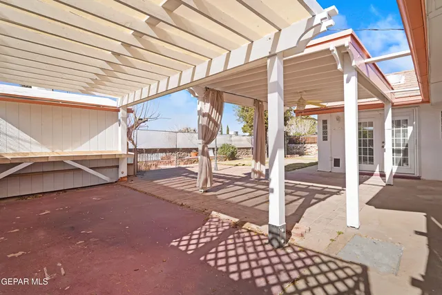 a view of a patio with table and chairs